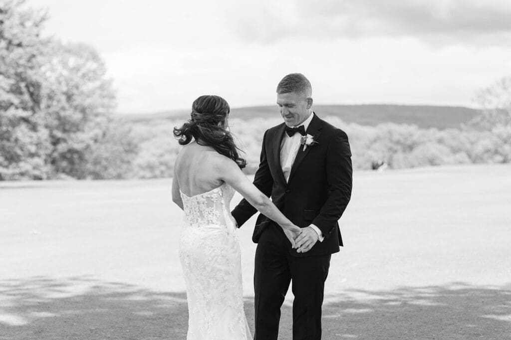 bride and groom enjoying a first look under a big oak tree