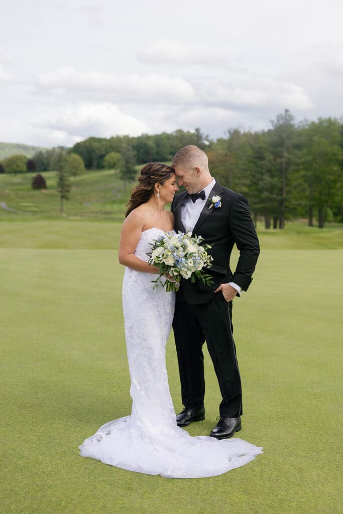 bride and groom resting their heads together during outdoor portraits