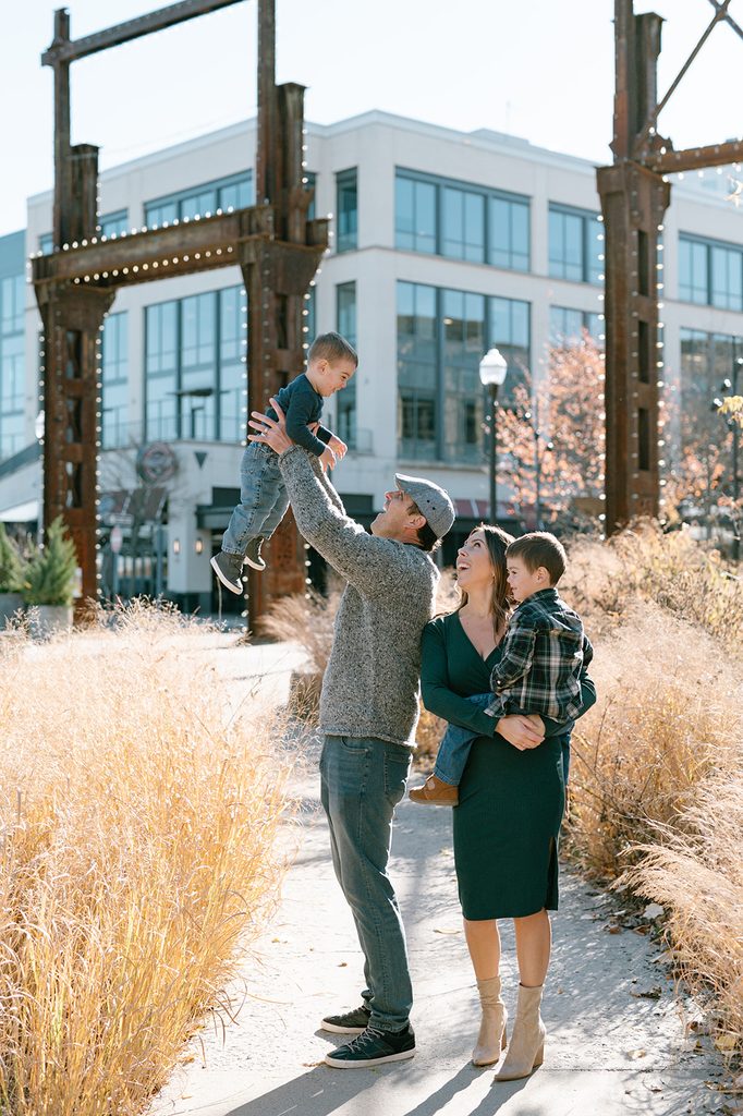 a family of four wearing coordinating outfits during fall family photos