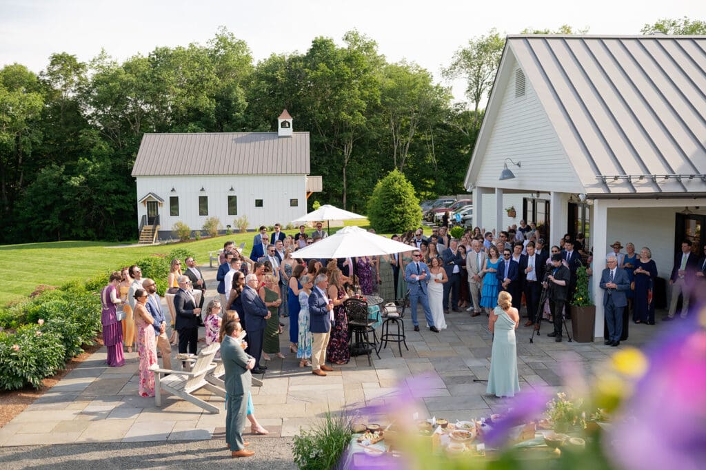 Wedding guests enjoying cocktail hour on the Bloom Meadows patio