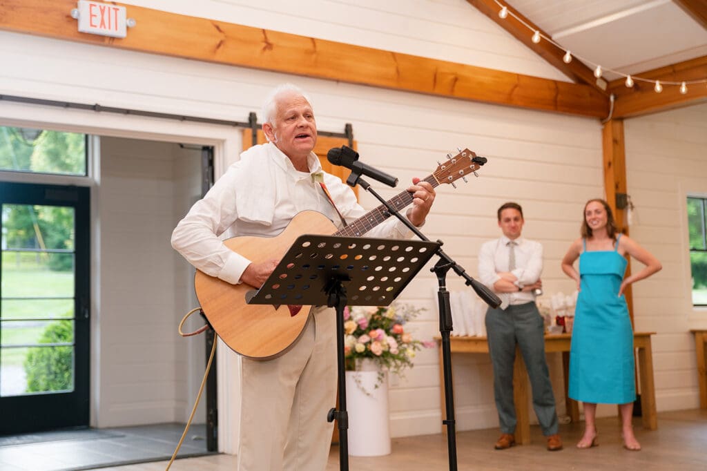 Bride dad performing a song inside the Bloom Meadows barn