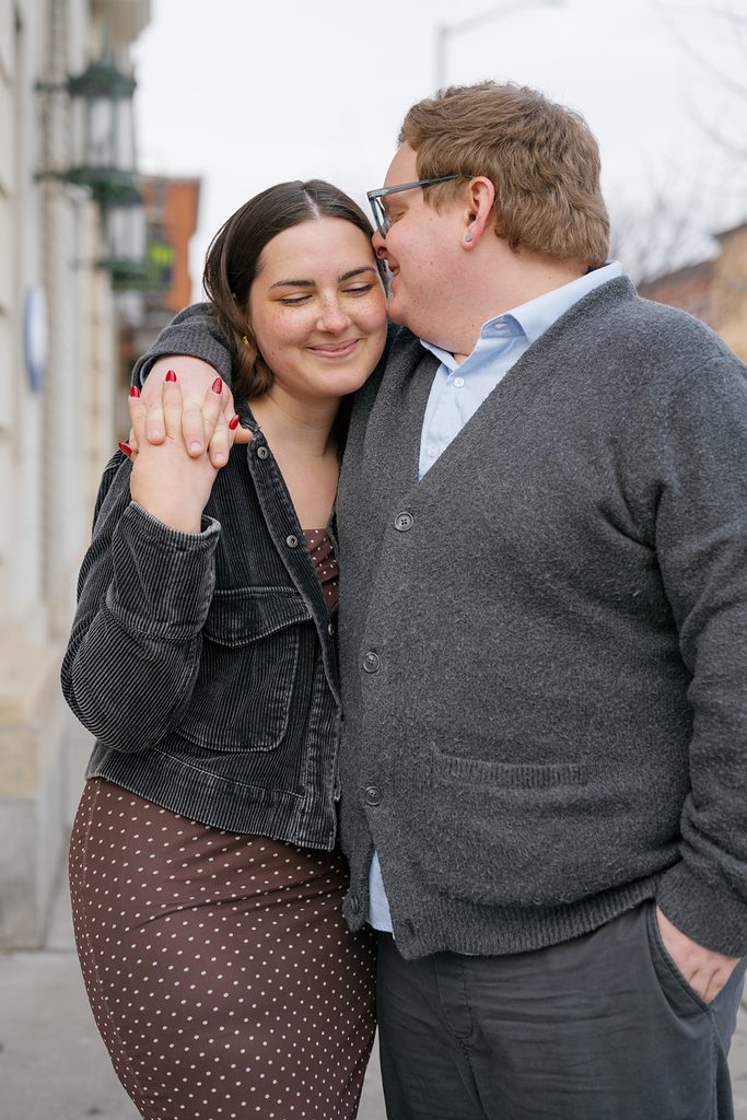 close up photo of a couple wearing neutral soft black corduroy and a knit cardigan