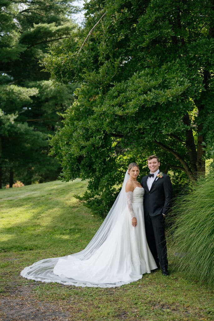 traditional portrait of a bride and groom looking at the camera