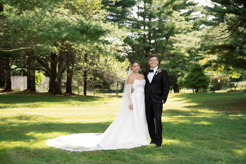 bride and groom looking at camera surrounded by beautiful lighting