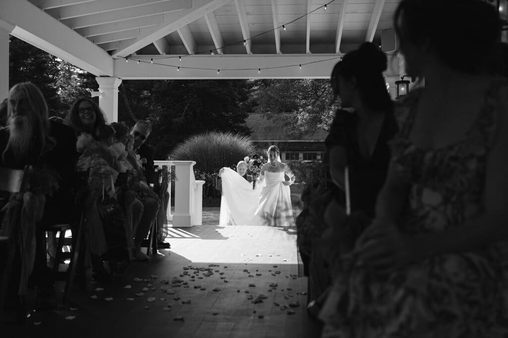 black and white photo of bride approaching the top of the aisle
